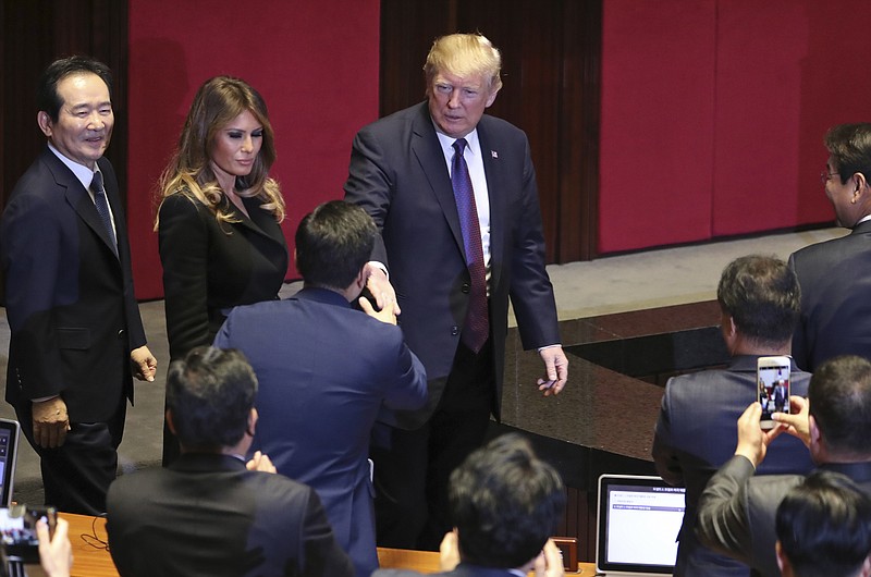 President Donald Trump, center, and first lady Melania Trump, center left, arrive at the South Korean National Assembly, Wednesday, November, 8, 2017, in Seoul, South Korea. Trump is on a five country trip through Asia traveling to Japan, South Korea, China, Vietnam and the Philippines. (AP Photo/Andrew Harnik)