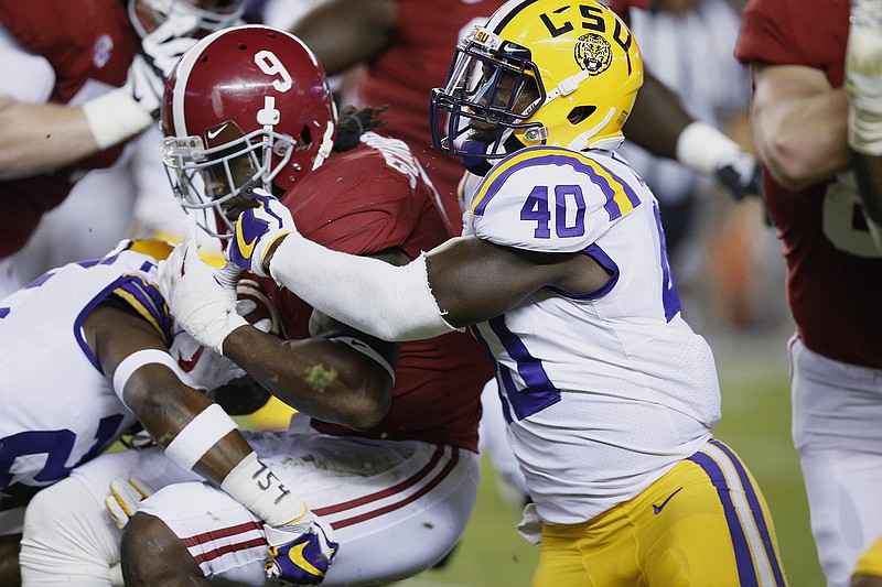 LSU linebacker Devin White, right, works to bring down Alabama running back Bo Scarbrough during last Saturday night's SEC West matchup in Tuscaloosa.