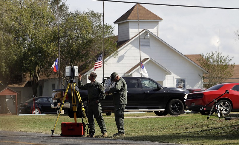 Law enforcement officials continue to investigate the scene of a shooting at the First Baptist Church of Sutherland Springs, Tuesday, Nov. 7, 2017, in Sutherland Springs, Texas. A man opened fire inside the church in the small South Texas community on Sunday, killing more than two dozen and injuring others. (AP Photo/Eric Gay)