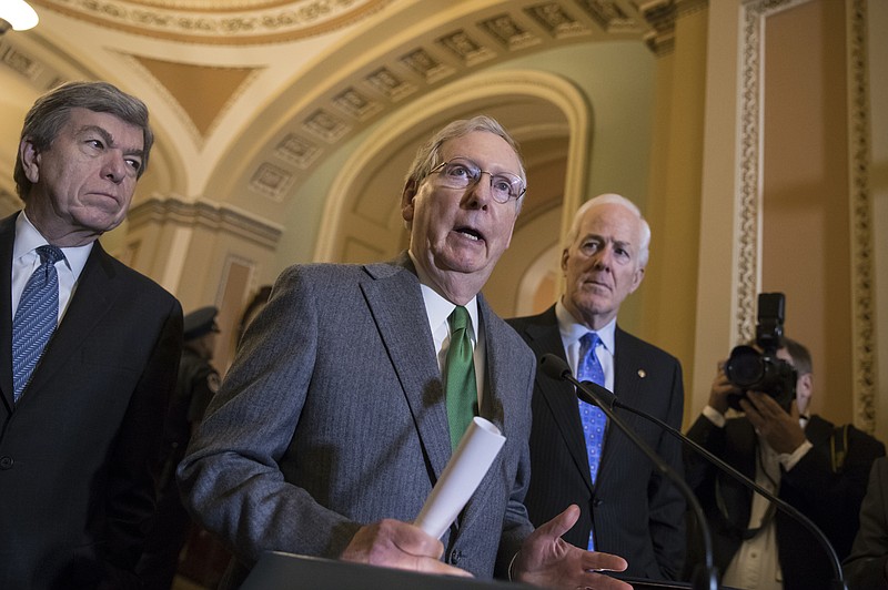 Senate Majority Leader Mitch McConnell, R-Ky., flanked by Sen. Roy Blunt, R-Mo., left, and Majority Whip John Cornyn, R-Texas, speaks to reporters following a closed-door strategy session that included Vice President Mike Pence, on Capitol Hill in Washington, Tuesday, Nov. 7, 2017. (AP Photo/J. Scott Applewhite)