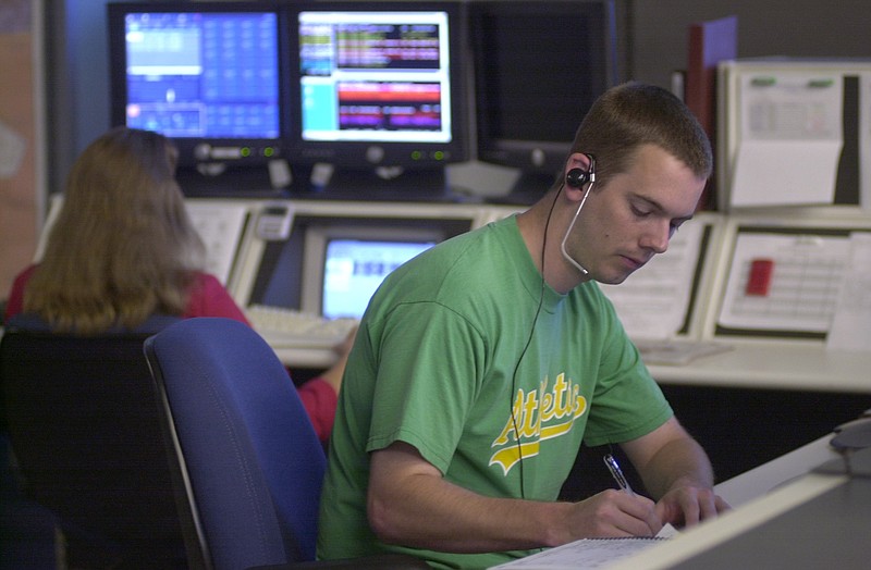 In this 2003 staff file photo, Hamilton County 911 Emergency dispatcher Dennis Witt takes a call at the call center on Amnicola Highway.
