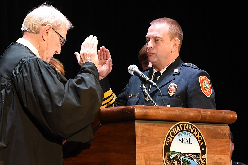 Newly appointed Chattanooga Fire Chief Philip Hyman, right, is sworn in by the Honorable Russell Bean Thursday inside the Walker Theatre at Memorial Auditorium.