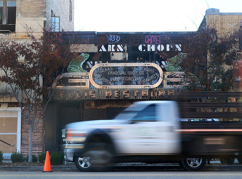 Traffic passes the old Ellis Restaurant building on Market Street in downtown Chattanooga, Tenn., where two of the five frogs were put up on the sign Thursday, Nov. 9, 2017. The frogs went back up after a repair job that took about four years. 