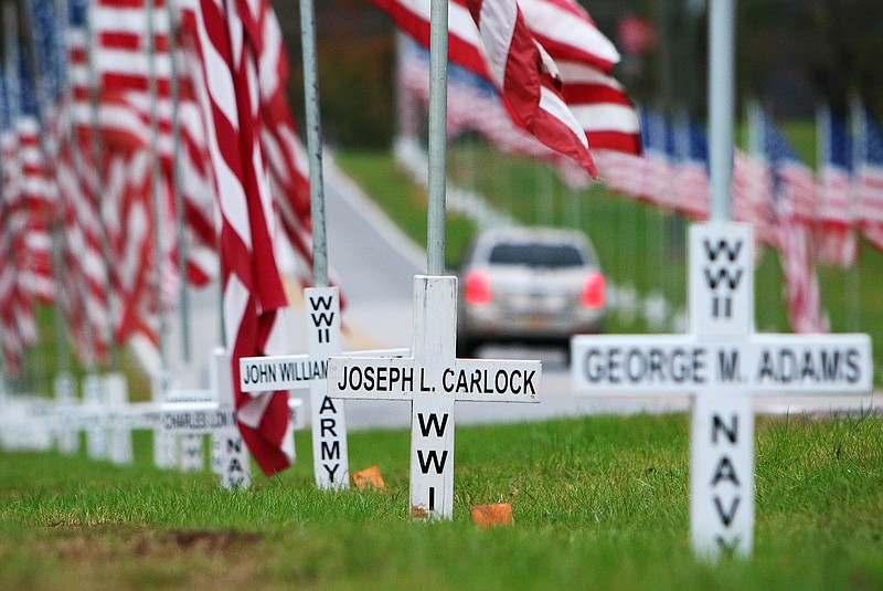 Crosses that anchor American flags line Robin Road in Ringgold, Ga., Wednesday Nov. 8, 2017. This tradition of honoring deceased veterans began in 1970 with Ringgold's Veterans of Foreign Wars of the United States, Post 8153.