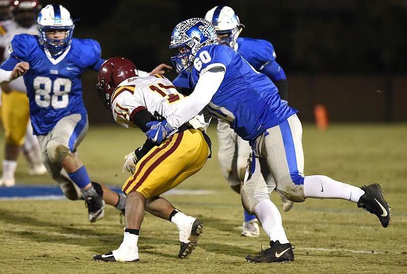 Trion's Braxden Peace (60) stops Dooley's Reggie Smith (11) for a loss.  The Dooley County Bobcats visited the Trion Bulldogs in the first round of the GHSA football playoffs on November 10, 2017. 