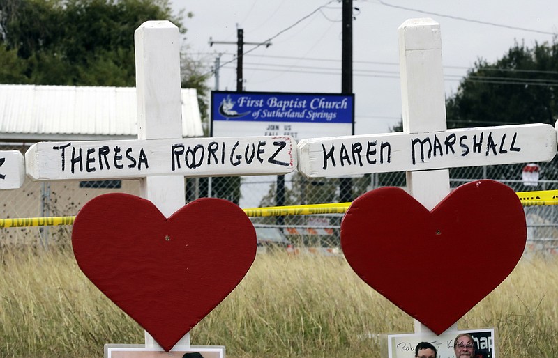 Crosses showing shooting victims names stand near the First Baptist Church on Thursday, Nov. 9, 2017, in Sutherland Springs, Texas. A man opened fire inside the church in the small South Texas community on Sunday, killing more than two dozen and injuring others. (AP Photo/David J. Phillip)