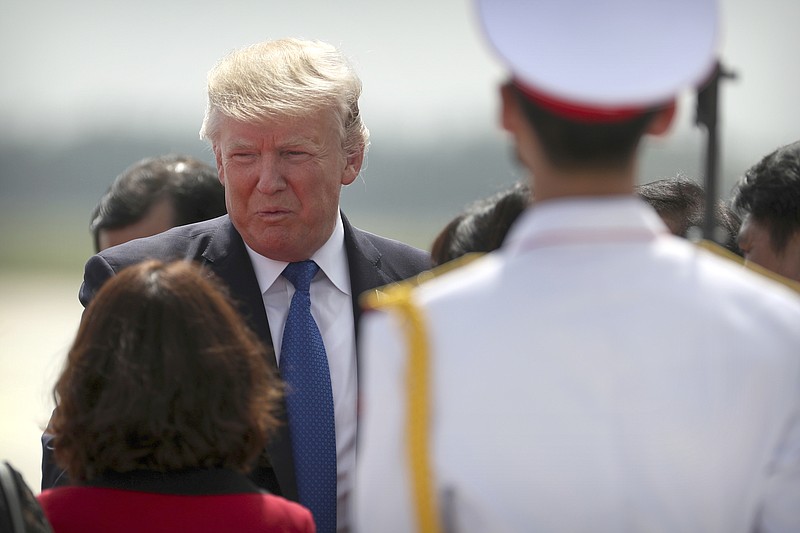 U.S. President Donald Trump arrives at Danang International Airport in Danang, Vietnam, Friday, Nov. 10, 2017. (AP Photo/Mark Schiefelbein)