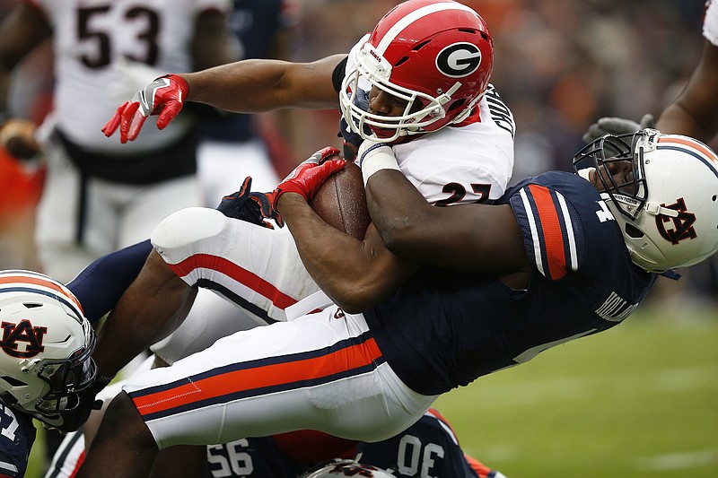 Georgia running back Nick Chubb is tackled by Auburn linebacker Jeff Holland during the first half of an NCAA college football game on Saturday, Nov. 11, 2017, in Auburn, Ala. (AP Photo/Brynn Anderson)