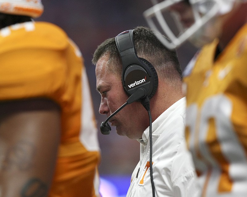 Tennessee head coach Butch Jones walks with the huddle during the Chick-fil-A Kickoff Game against Georgia Tech at Mercedes-Benz Stadium on Monday, Sept. 4, in Atlanta, Ga.