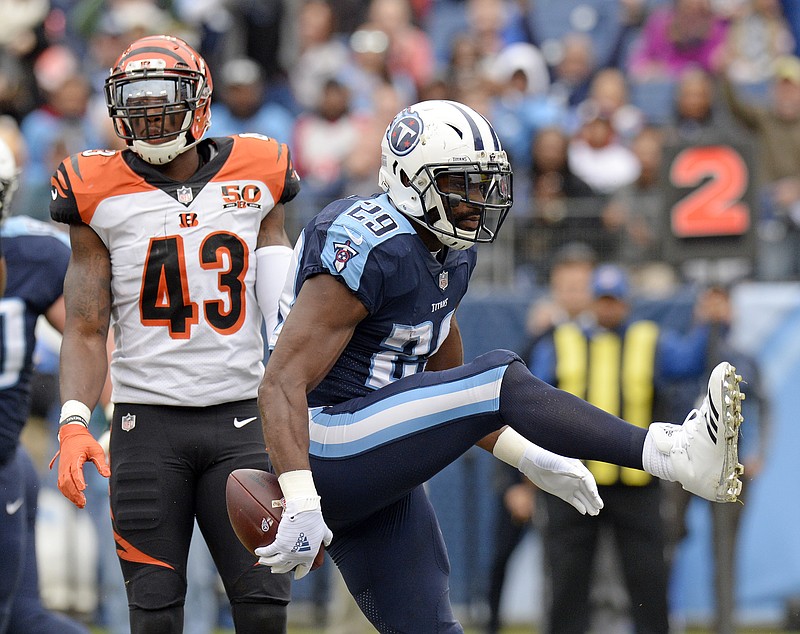 Tennessee Titans running back DeMarco Murray celebrates in front of Cincinnati Bengals free safety George Iloka after Murray scored on a 2-yard touchdown run in the first quarter Sunday in Nashville. The Titans won 24-20.