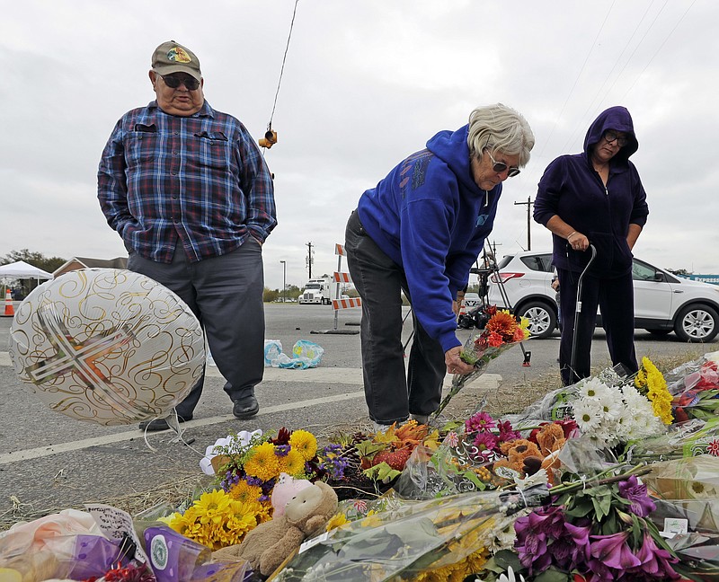 Visitors place flowers at a makeshift memorial for the victims of the Nov. 5 First Baptist Church shooting in Sutherland Springs, Texas.