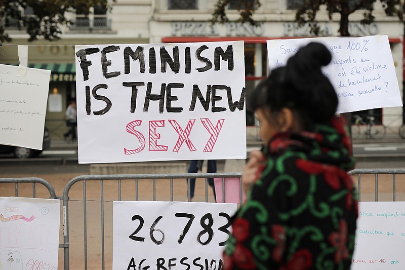 A woman reads a banner during a demonstration to support the wave of testimonies denouncing cases of sexual harassment, in Lyon, France in October. French women were protesting sexual abuse and harassment in 11 cities across the country under the #MeToo banner following the allegations against Hollywood mogul Harvey Weinstein. (AP Photo/Laurent Cipriani)