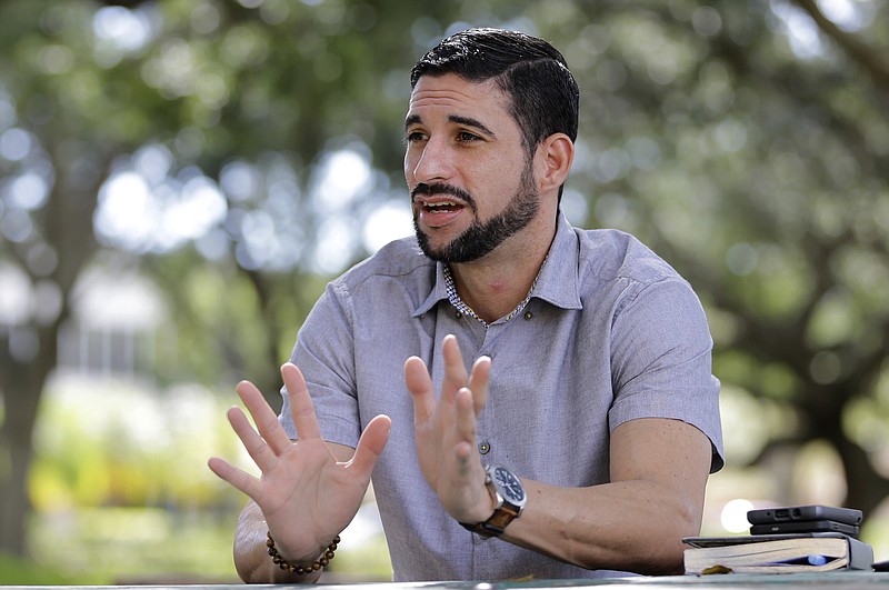 
              In this photo taken Wednesday, Nov. 8 2017, Javier Gonzalez talks to a reporter in Hialeah, Fla. Gonzalez has joined the tens of thousands of Puerto Ricans moving to Florida after Hurricane Maria, grateful for a place to start over but not without resentment over how his island was treated in the disaster. (AP Photo/Alan Diaz)
            