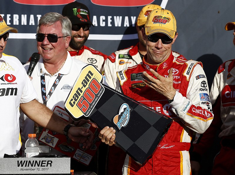 Matt Kenseth reacts after his winner's trophy broke as he picked it up in Victory Lane after a NASCAR Cup Series auto race at Phoenix International Raceway Sunday, Nov. 12, 2017, in Avondale, Ariz. (AP Photo/Ross D. Franklin)