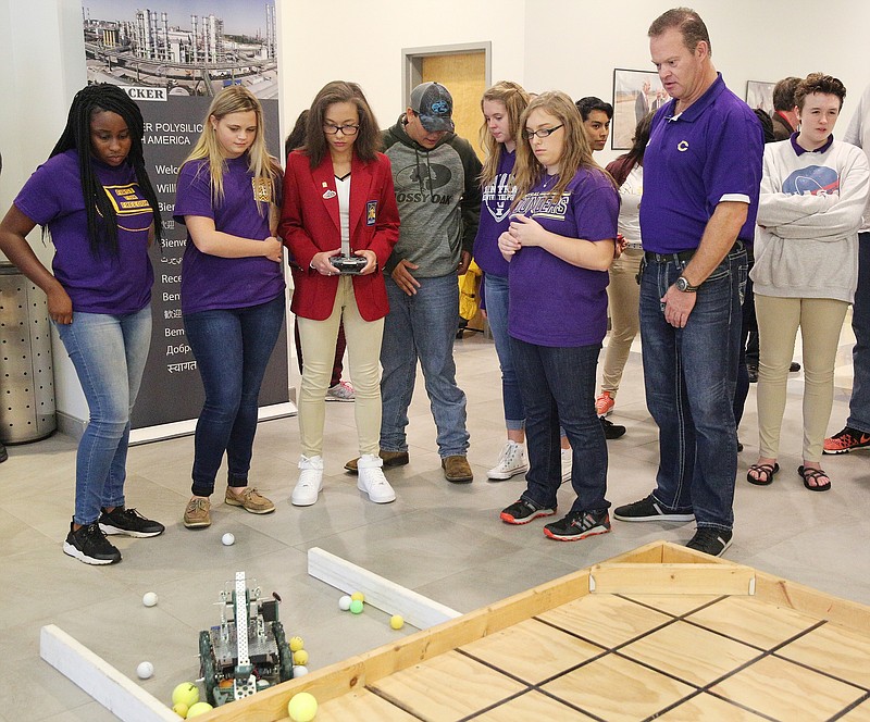 From left, CHS' Skills USA/STEM robotics teammates Nia Townsend, 15, Madison Brooks, 16, Alexis Massengale, 17, Chelsea Childress, 15, and Peyton Anderson, 15, get instructions from their coach Chip Strickland as they test their robot before the competition.