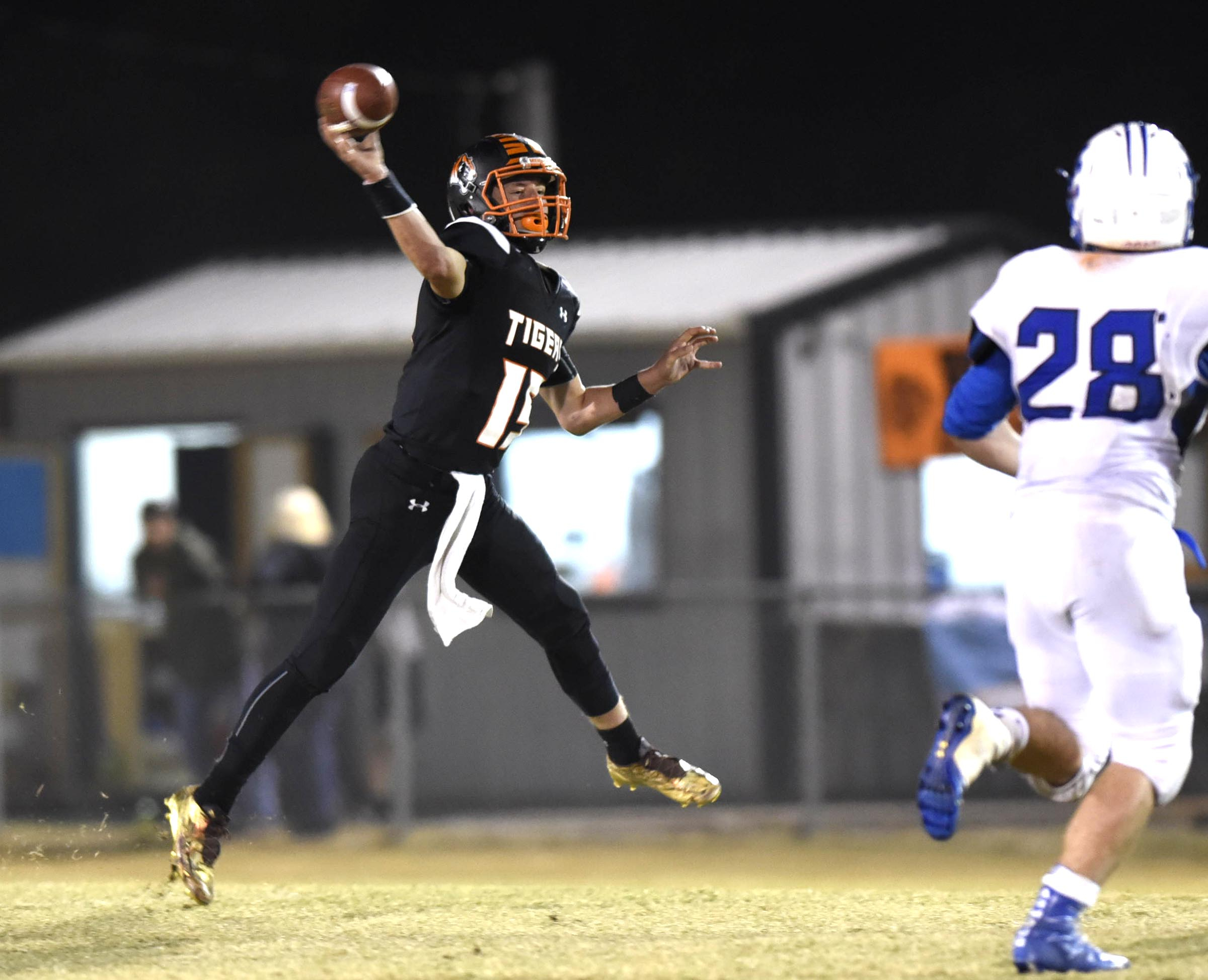 Meigs County quarterback Aaron Swafford (19) throws a pass on the run. The Jackson County Blue Devils visited the Meigs County Tigers in the first round of the TSSAA playoff on November 4, 2016.