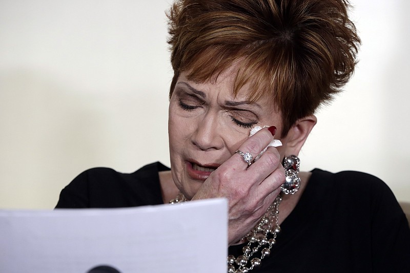 Beverly Young Nelson, the latest accuser of Alabama Republican Roy Moore, reads her statement at a news conference, in New York, Monday, Nov. 13, 2017. Nelson says Moore assaulted her when she was 16 and he offered her a ride home from a restaurant where she worked. Moore says the latest allegations against him are a "witch hunt." (AP Photo/Richard Drew)