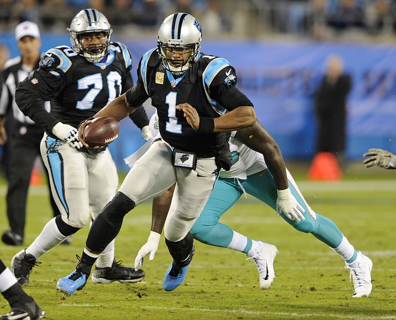 Carolina Panthers' Cam Newton (1) runs for a first down against the Miami Dolphins in the first half of an NFL football game in Charlotte, N.C., Monday, Nov. 13, 2017. (AP Photo/Mike McCarn)