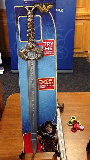 A Wonder Woman "battle sword" is displayed during a news conference Tuesday, Nov. 14, 2017, in Boston, where the child safety group World Against Toys Causing Harm, or W.A.T.C.H., released its annual holiday list of the 10 most hazardous toys. (AP Photo/Philip Marcelo)