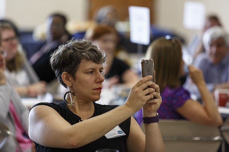 Ariel Ford takes a picture with her phone during an update on the Chattanooga 2.0 initiative on the campus of the University of Tennessee at Chattanooga on Thursday, July 13, 2017, in Chattanooga.