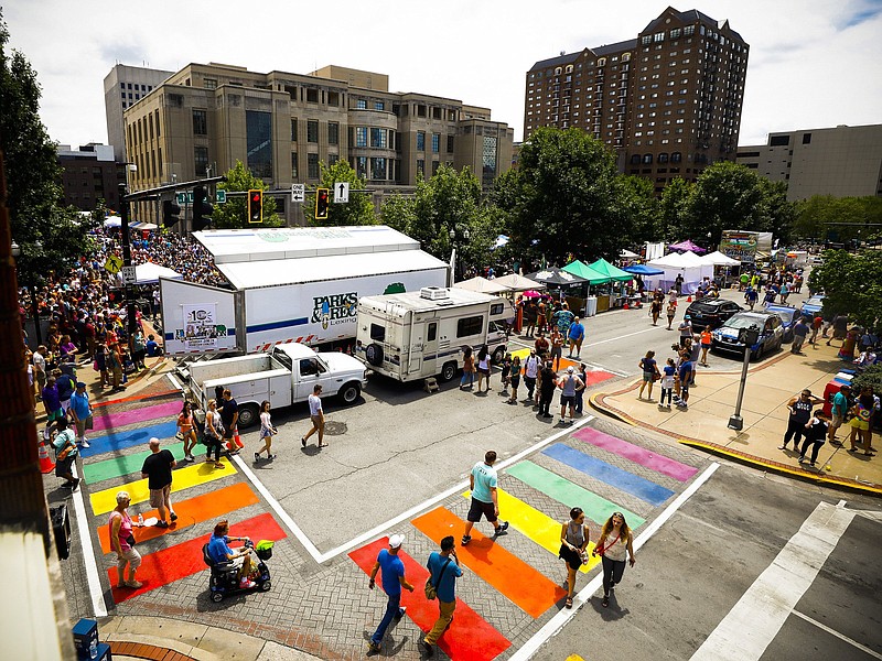 
              In this Saturday, June 24, 2017 photo, pedestrians use the rainbow crosswalks at the corner of North Limestone Street and Short Street during the 10th annual Lexington Pride Festival at the Robert F. Stephens Courthouse Plaza in Lexington, Ky. The rainbow-colored crosswalk honoring the LGBT community in Lexington is a distracting safety hazard and should be removed, a federal official says. Officials painted the crosswalk at the busy intersection across from the county courthouse earlier this year to coincide with the annual gay pride festival. At the time, city officials said the crosswalk would be safer because it would better catch the attention of drivers.  (Alex Slitz/Lexington Herald-Leader via AP)
            