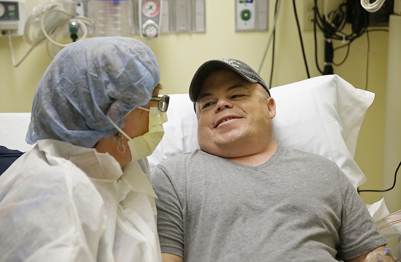 Brian Madeux, 44, sitting with his girlfriend Marcie Humphrey, waits to receive the first human gene editing therapy for NPS, at the UCSF Benioff Children's Hospital in Oakland, Calif., on Monday, Nov. 6, 2017. Through an IV, Madeux will receive billions of copies of a corrective gene and a genetic tool to cut his DNA in a precise spot. "It's kind of humbling" to be the first to test this, said Madeux, who has a metabolic disease called Hunter syndrome. (AP Photo/Eric Risberg)