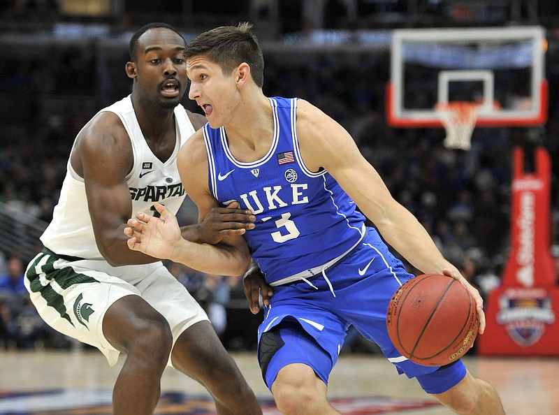 Duke guard Grayson Allen (3) drives on Michigan State guard Joshua Langford during the first half of an NCAA college basketball game Tuesday, Nov. 14, 2017, in Chicago. (AP Photo/Paul Beaty)