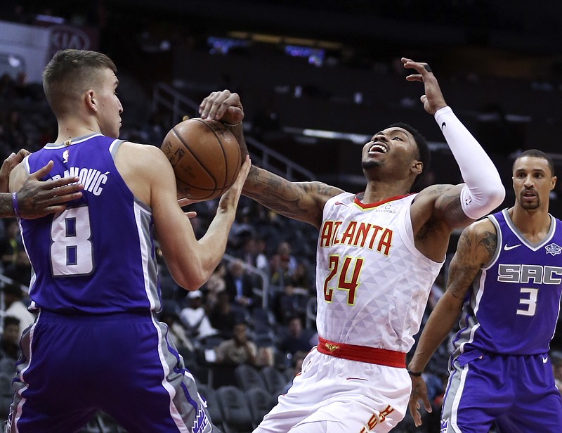 Atlanta Hawks guard Kent Bazemore (24) looses the ball as he drives against Sacramento Kings guard Bogdan Bogdanovic (8) during the first half of an NBA basketball game Wednesday, Nov. 15, 2017, in Atlanta. (AP Photo/John Bazemore)