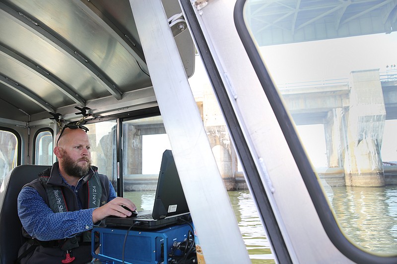 Benjamin Phillips, a dam safety inspector with the Tennessee Valley Authority, uses TVA's new 3D scanning sonar technology to perform a dam inspection at Chickamauga Dam Thursday, Nov. 16, 2017,  in Chattanooga, Tenn. TVA can more quickly and efficiently inspect dams with the sonar equipment.