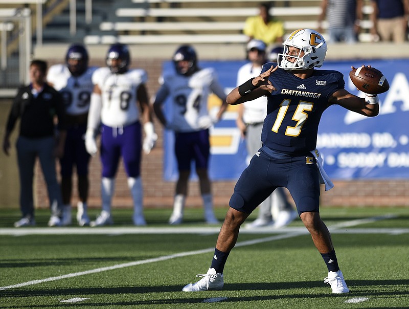 UTC quarterback Alejandro Bennifield (15) looks to pass on a flea flicker play, on his first snap of the season, against Western Carolina at Finley Stadium on Saturday, Sept. 30, in Chattanooga, Tenn. Bennifield was suspended for the first four games of the season.