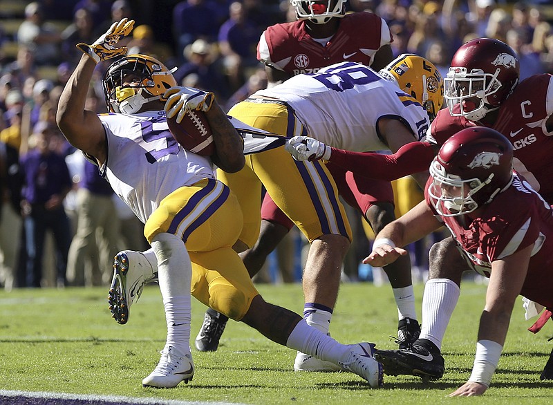 LSU running back Derrius Guice is stopped short of the goal line by a jersey tug from Arkansas defensive back Santos Ramirez during the Tigers' 33-10 win Saturday in Baton Rouge. Guice and the Tigers will visit Tennessee this Saturday for the Vols' first game under interim coach Brady Hoke.