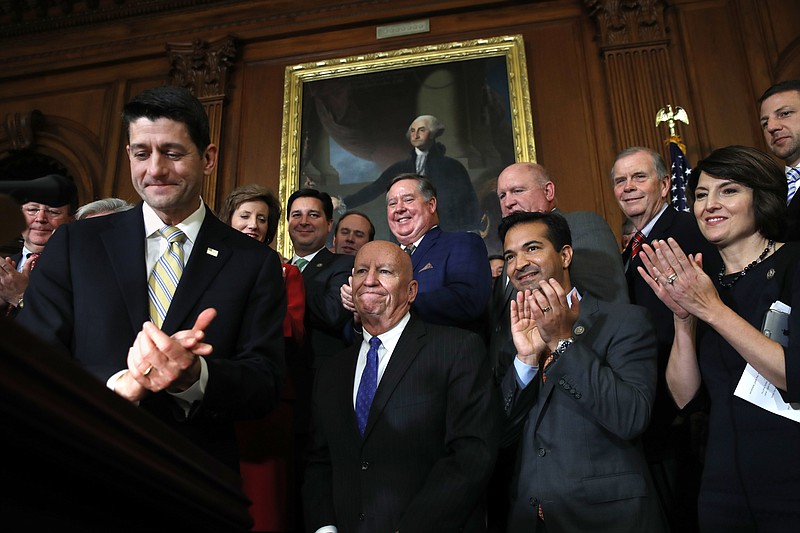 
              House Speaker Paul Ryan of Wis., left, leads applause for House Ways and Means Chair Rep. Kevin Brady, R-Texas, along with Rep. Carlos Curbelo, R-Fla., and Rep. Cathy McMorris Rodgers, R-Wash., during a news conference following a vote on tax reform on Capitol Hill in Washington, Thursday, Nov. 16, 2017. Republicans passed a near $1.5 trillion package overhauling corporate and personal taxes through the House, edging President Donald Trump and the GOP toward their first big legislative triumph in a year in which they and their voters expected much more. (AP Photo/Jacquelyn Martin)
            
