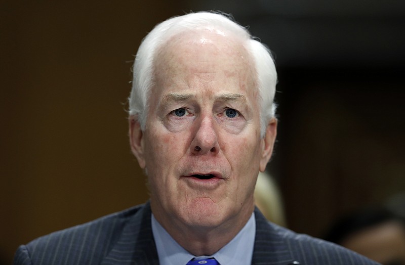 In this Sept. 19, 2017, file photo, Sen. John Cornyn, R-Texas, testifies during a hearing of the Senate Foreign Relations Committee on Capitol Hill in Washington. A bipartisan group of senators has introduced legislation designed to ensure federal and state governments accurately report relevant criminal history records to the FBI's database of prohibited gun buyers. (AP Photo/Alex Brandon)