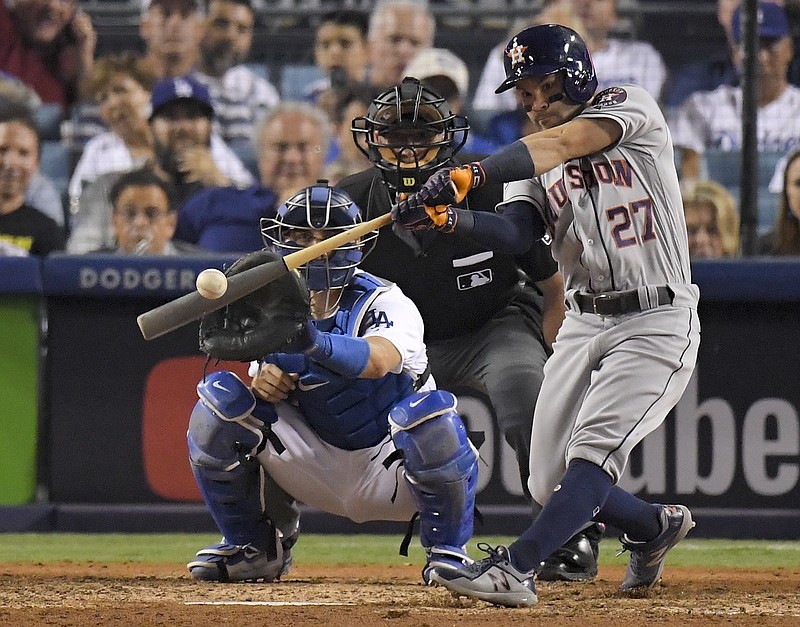 In this Oct. 25, 2017, file photo, Houston Astros' Jose Altuve hits a home run against the Los Angeles Dodgers during the 10th inning of Game 2 of baseball's World Series in Los Angeles. Houston dynamo Jose Altuve and Yankees slugger Aaron Judge are the favorites for the AL MVP award while Miami masher is the top candidate for the NL prize. (AP Photo/Mark J. Terrill, File)