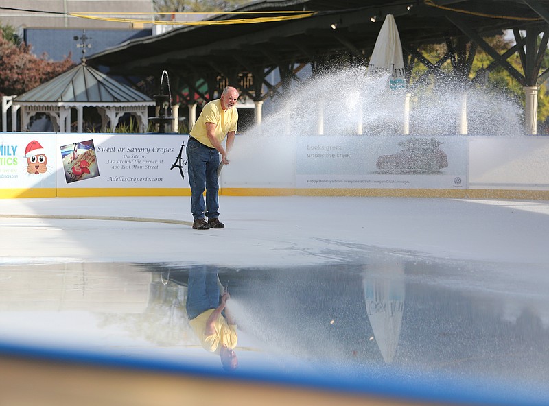 Bill Matthews with Chattanooga Presents sprays water on the rink at Ice on the Landing at the Choo Choo Gardens in Chattanooga, Tenn., on Wednesday, Nov. 15, 2017. It has taken Matthews about a week to make the ice thick enough for skating. 