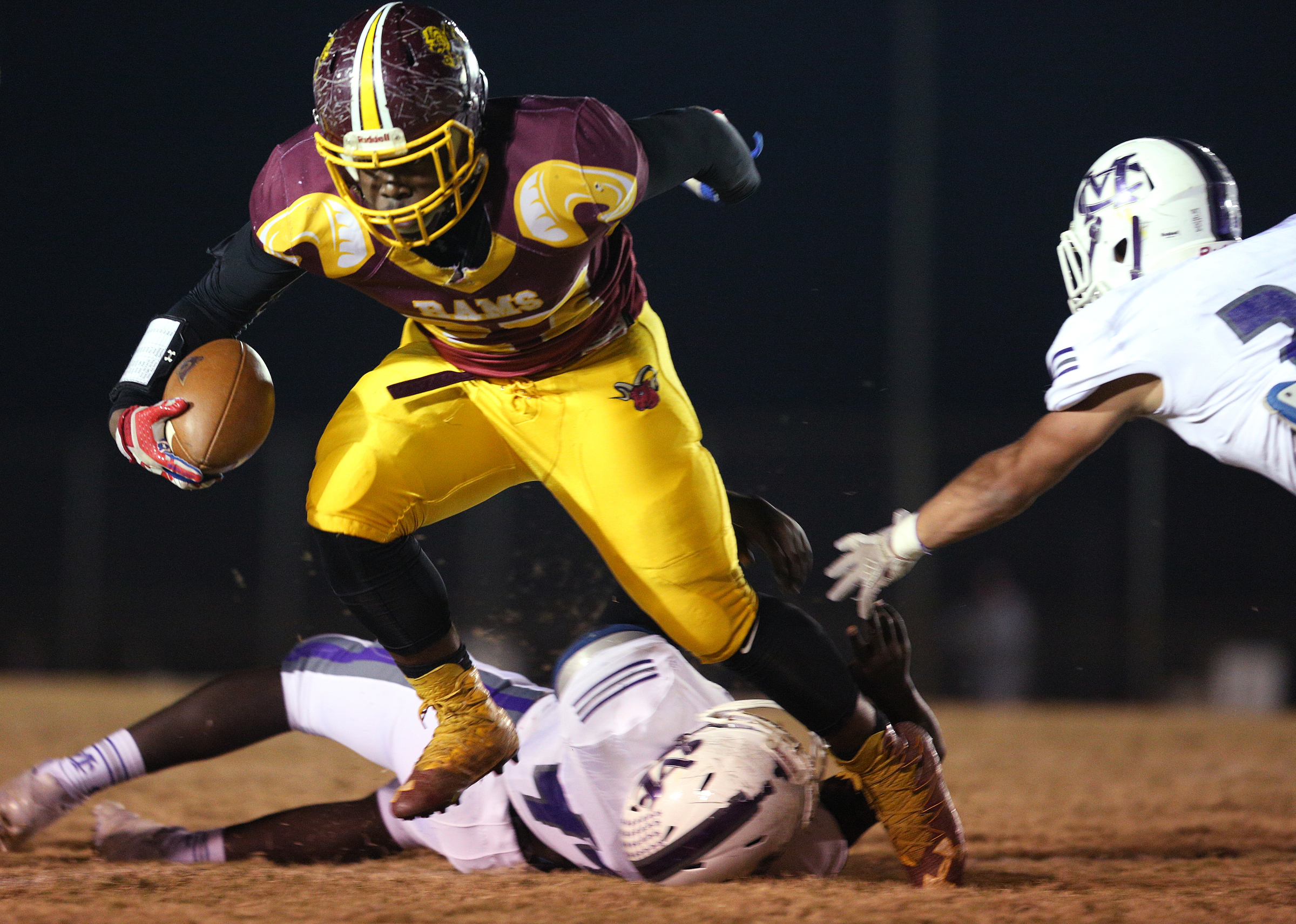 Tyner's Tyon Young (27) is slowed down by Marion County players Ermiyas Bowden (44) and Brett Nelson (21) during the Class 2A quarterfinal football game between Tyner and Marion County Friday, Nov. 17, 2017 in Bob Evans Stadium at Tyner High School.