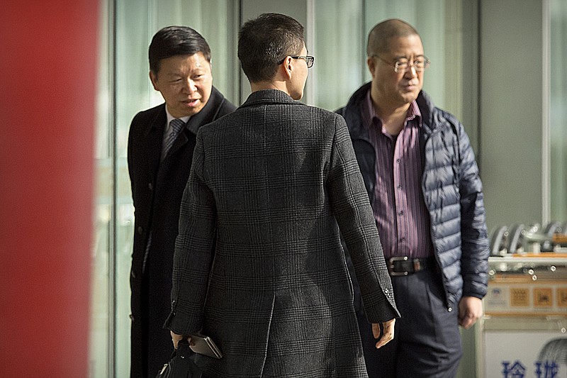 Song Tao, left, the head of China's ruling Communist Party's International Liaison Department, arrives at Beijing Capital International Airport in Beijing, Friday, Nov. 17, 2017. Chinese state media said Song would travel to Pyongyang on Friday to report on the party's national congress held last month. Song would be the first ministerial-level Chinese official to visit North Korea since October 2015. (AP Photo/Mark Schiefelbein)