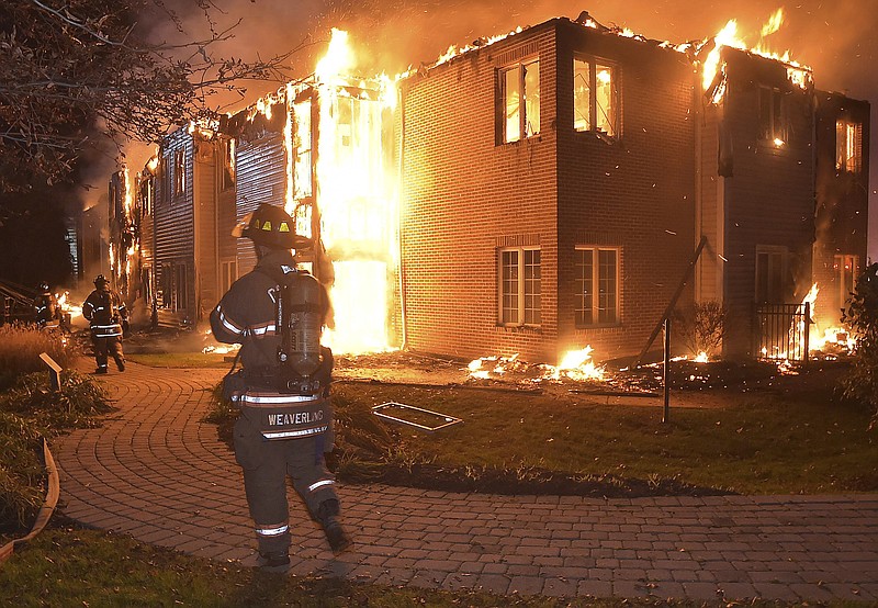 Firefighters battle a blaze at the Barclay Friends Senior Living Community in West Chester, Pa., Thursday, Nov. 16, 2017. Chester County emergency officials say at least 20 people have been taken to area hospitals for treatment. The extent of their injuries was not immediately known. (Pete Bannan/Daily Local News via AP)
