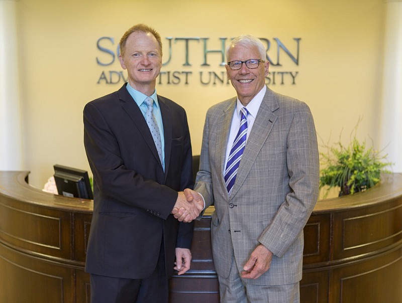 It Is Written Director John Bradshaw, left, shakes hands with former Southern Adventist University President Gordon Bietz. The two Adventist institutions are furthering their partnership with It Is Written's new ministry headquarters being built on land recently purchased from SAU.