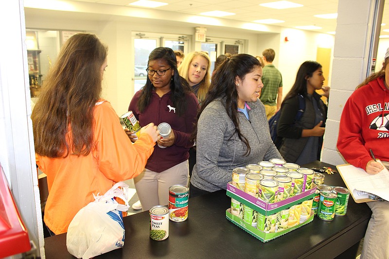 Members of the Leadership Class at Ooltewah High School help collect cans for the food drive.