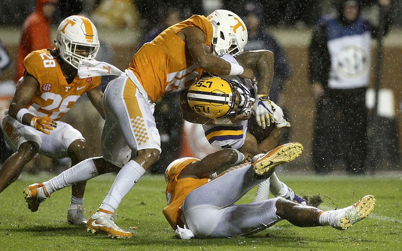 Tennessee defensive backs Nigel Warrior (18) and Micah Abernathy (22) stop LSU running back Derrius Guice (5) during an NCAA football game at Neyland Stadium on Saturday, Nov. 18, 2017 in Knoxville, Tenn.