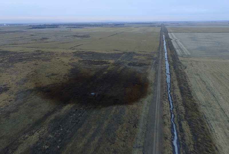 This aerial photo shows spills from TransCanada Corp.'s Keystone pipeline, Friday, Nov. 17, 2017, that leaked an estimated 210,000 gallons of oil onto agricultural land in northeastern South Dakota, near Amherst, S.D., the company and state regulators said Thursday, but state officials don't believe the leak polluted any surface water bodies or drinking water systems. Crews shut down the pipeline Thursday morning and activated emergency response procedures after a drop in pressure was detected resulting from the leak south of a pump station in Marshall County, TransCanada said in a statement. The cause was being investigated. (DroneBase via AP)