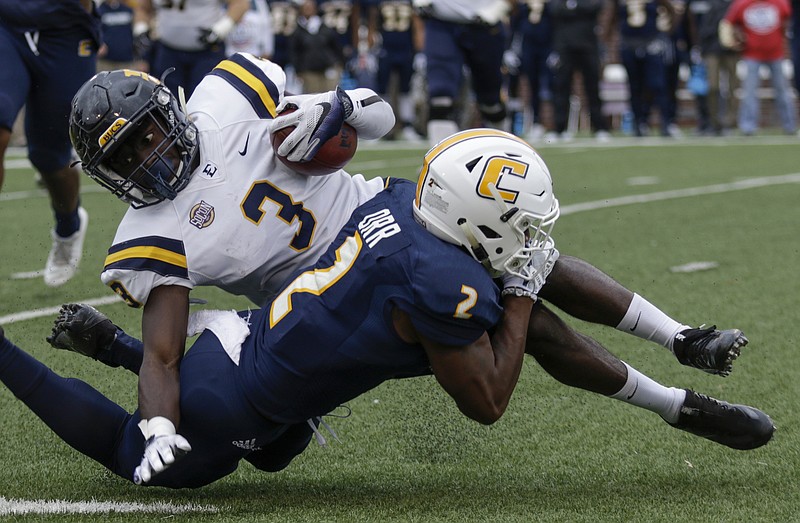 UTC defensive back Kareem Orr tackles ETSU defensive back Markell Boston during the Mocs' season finale Saturday at Finley Stadium. The Mocs prevailed 10-3, giving them wins in two of their final three games.