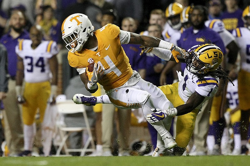 Tennessee running back John Kelly escapes LSU defensive back Donte Jackson during Saturday night's game at Neyland Stadium. Kelly completed a pass to junior walk-on Malik Elion for a 10-yard gain and a first down during the game.