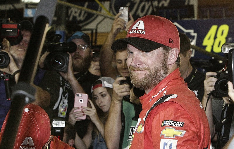 Dale Earnhardt Jr. is surrounded upon getting out of his car after a NASCAR Cup Series auto race at Homestead-Miami Speedway in Homestead, Fla., Sunday, Nov. 19, 2017. Earnhardt is retiring from full-time racing. (AP Photo/Terry Renna)