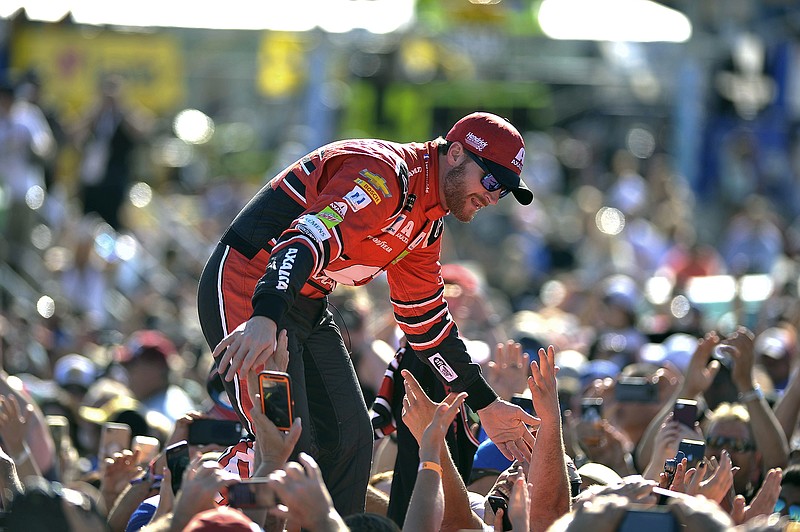 Dale Earnhardt Jr. greets fans as he is introduced before Sunday's NASCAR race at Homestead-Miami Speedway.