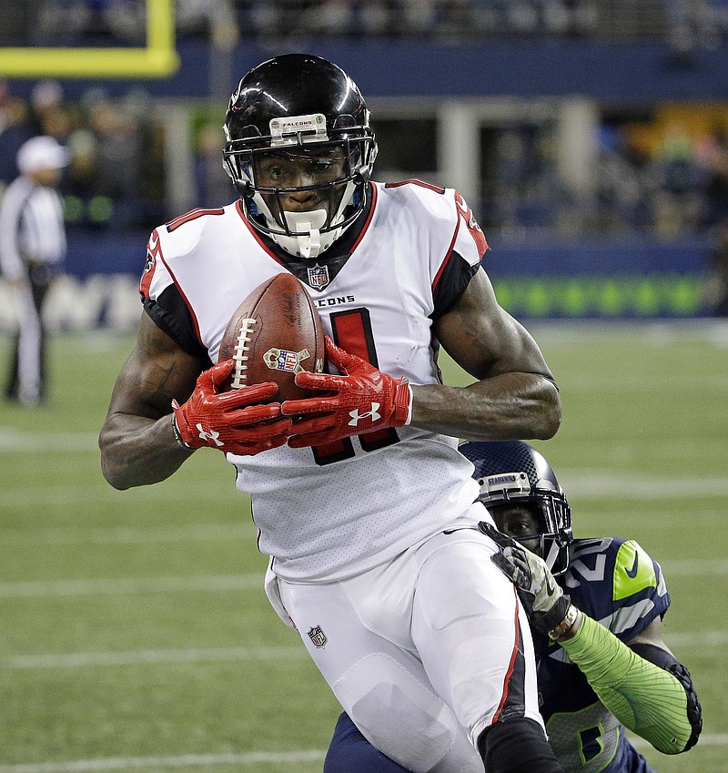 
              Atlanta Falcons' Julio Jones pulls down a pass in front of Seattle Seahawks' Jeremy Lane in the second half of an NFL football game, Monday, Nov. 20, 2017, in Seattle. (AP Photo/Ted S. Warren)
            