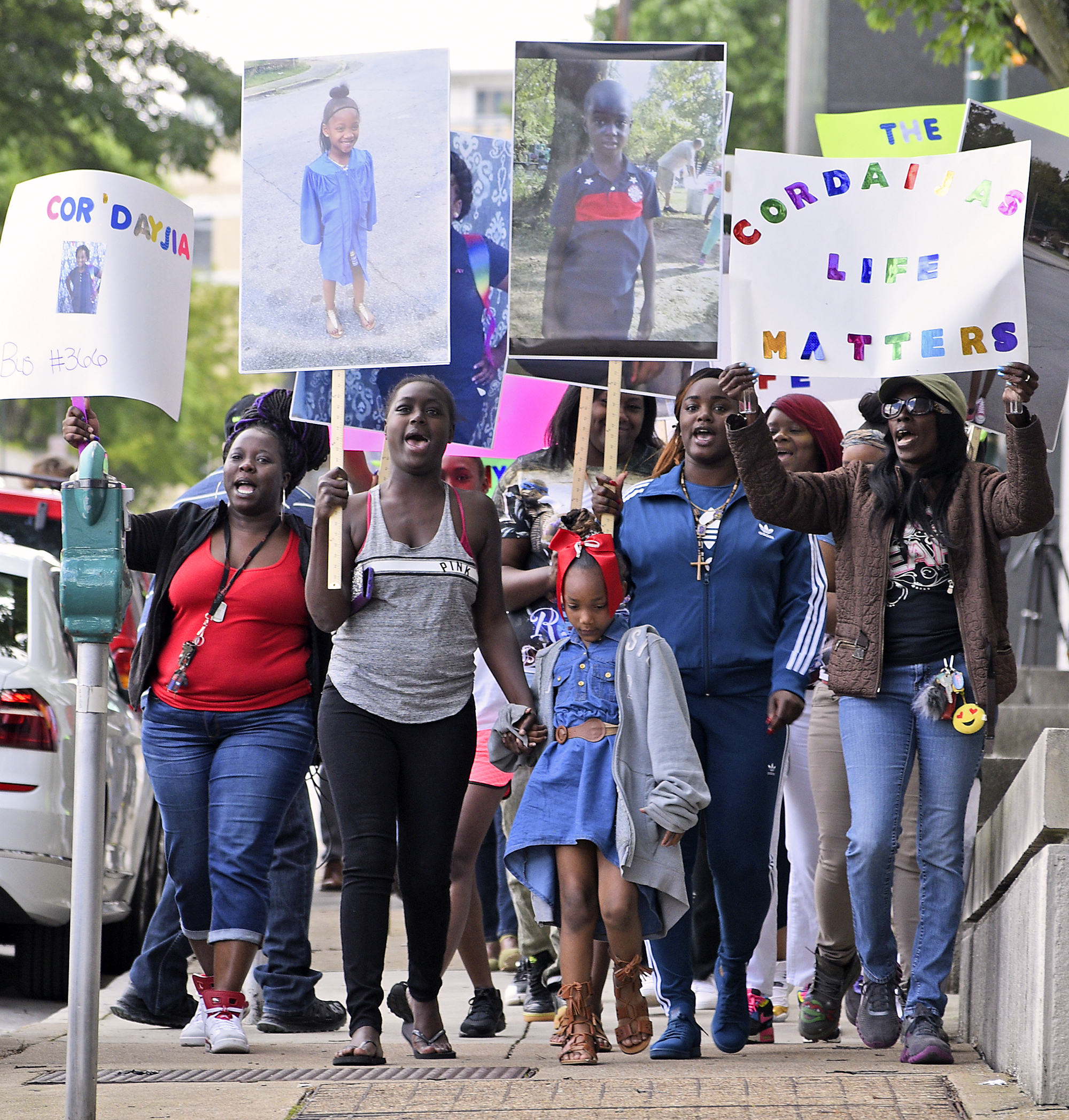 Protestors begin their march on the sidewalk along East 6th Street. A march was held downtownon May 25, 2017 to remember the victims of the Woodmore Bus Crash and draw attention to Durham Transportation being retained as the contractor for the county's buses.