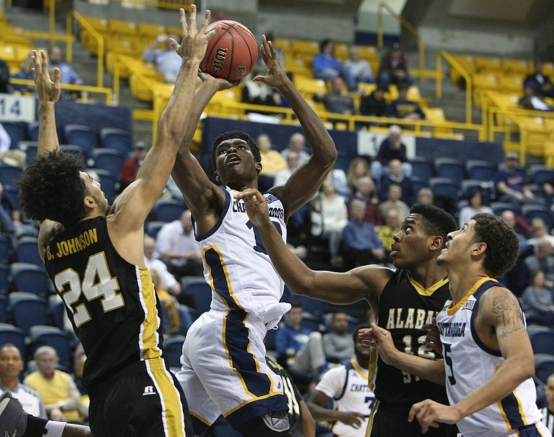 University of Tennessee at Chattanooga's James Lewis Jr. (10) puts up a shot while being guarded by Alabama State's Branden Johnson (24) and Reginald Gee (12) during the UTC basketball game against Alabama State in the Cayman Islands Classic Chattanooga Bracket Monday, Nov. 20, 2017 at McKenzie Arena in Chattanooga, Tenn. 