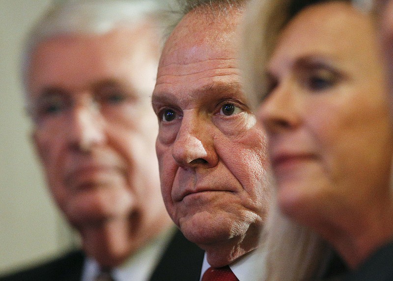 In this Thursday, Nov. 16, 2017, file photo, former Alabama Chief Justice and U.S. Senate candidate Roy Moore waits to speak at a news conference in Birmingham, Ala. (AP Photo/Brynn Anderson)